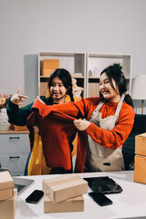 Portrait of Starting small businesses SME owners, two Asian woman check online orders Selling...