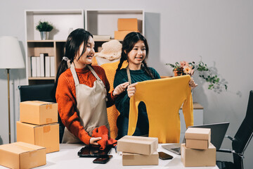 Portrait of Starting small businesses SME owners, two Asian woman check online orders Selling...