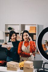 Portrait of Starting small businesses SME owners, two Asian woman check online orders Selling...