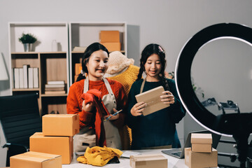 Portrait of Starting small businesses SME owners, two Asian woman check online orders Selling...