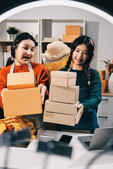 Portrait of Starting small businesses SME owners, two Asian woman check online orders Selling...
