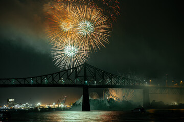 Drone flight through holiday fireworks above water with reflection on the black sky background