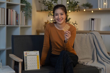 Empowered Health. Smiling woman holding medication pack, promoting wellness.