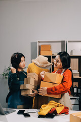 Portrait of Starting small businesses SME owners, two Asian woman check online orders Selling...