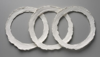 Three overlapping, textured white rings