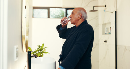 Bathroom, mirror and senior man drinking water for hydration in morning with getting ready. Relax,...
