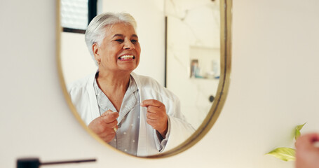 Dental health, mirror and senior woman with flossing in bathroom for morning routine in home. Oral...