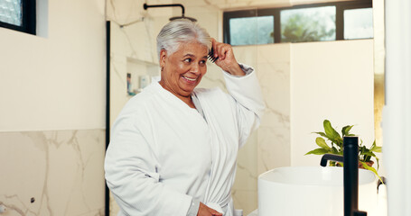 Senior woman, smile and brush hair in bathroom for beauty, healthy growth and grooming routine....