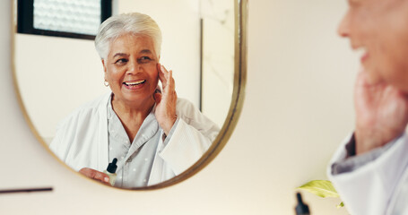 Serum, skincare and mirror with old woman in bathroom for beauty, anti aging and cosmetics....