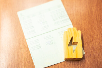 Bank account book and an electricity symbol, it is a concept of electricity production having...