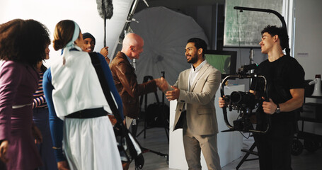 Handshake, teamwork and director in studio for creative production, filmmaking and shooting...