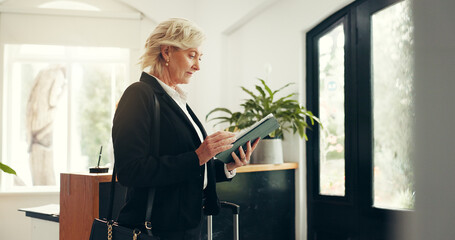 Business, woman and tablet at hotel reception for check in, reservation and booking confirmation....