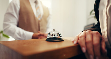 Customer, hands and concierge with service bell for request assistance or help in hotel. Closeup,...