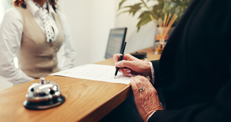 Hands, document and signature at hotel, writing or registration for accommodation at resort....
