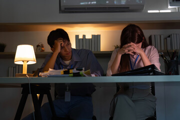 Stressed colleagues facing challenges in a dimly lit office