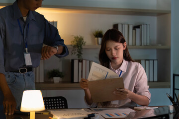 Time Management in Office. Professional checking watch while reviewing documents.