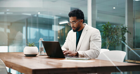 Businessman, laptop and typing at night with finance review, problem solving and stats report at...