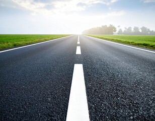 Empty road stretching into a bright hazy sky