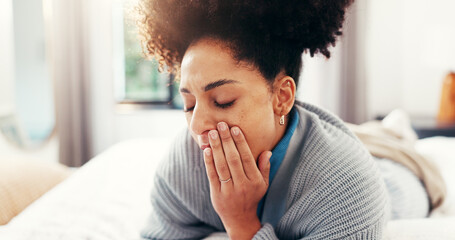 Sensitive, pain and woman with toothache on bed with cavity, root canal or impacted wisdom teeth....
