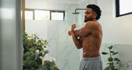 Stretching, arm and mirror with man in bathroom for morning routine, workout transformation and...