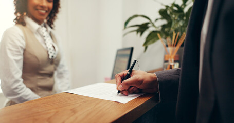 Hands, document and signature at hotel, concierge or registration for accommodation at resort....