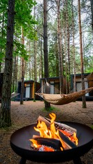 Obraz premium Cozy hammocks and a crackling bonfire create a relaxing atmosphere in the forest