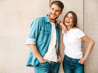 Portrait of smiling beautiful female and her handsome boyfriend. Woman in casual summer jeans...