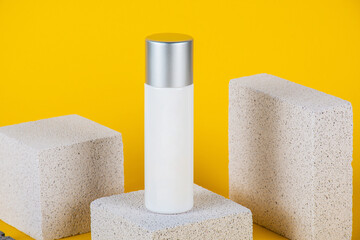 Plastic white tube for cream or lotion. Skin care or sunscreen cosmetic with stylish props on...