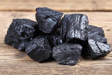 shilajit resin chunks on weathered oak. 