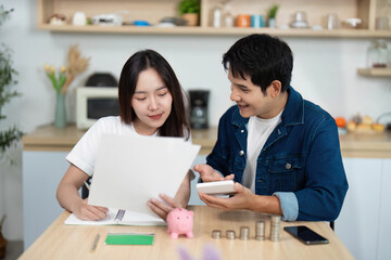Couple Collaborating on Financial Planning with Piggy Bank and Notes.