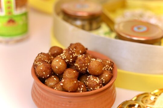 Anarsa balls fried indian sweet dish coated with white sesame seeds