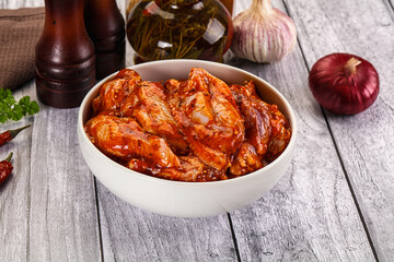 Raw marinated buffalo chicken wings