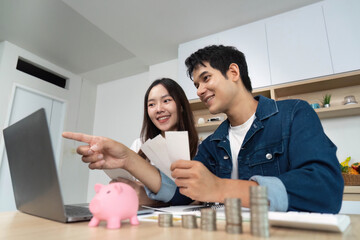 Financial Planning and Budgeting. Young couple discussing savings and expenses at home.