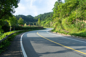 empty asphalt through mountain as background