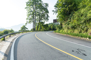 empty asphalt through mountain as background