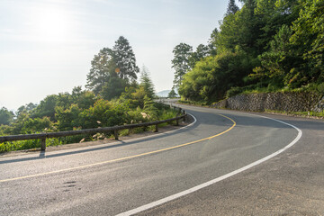 empty asphalt through mountain as background