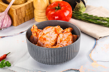 Raw marinated uncooked chicken wings