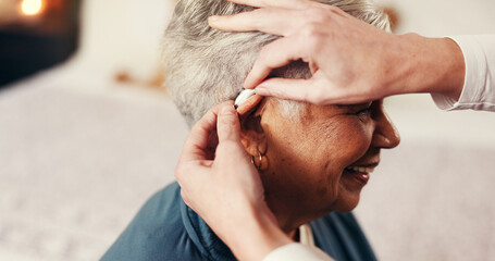 Hands, senior woman and hearing aid with nurse, smile or help with fitting in retirement home....