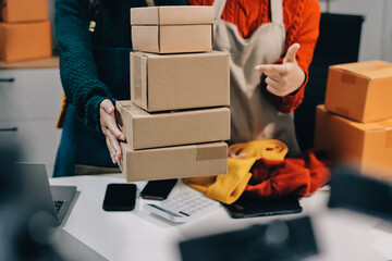 Portrait of Starting small businesses SME owners, two Asian woman check online orders Selling...