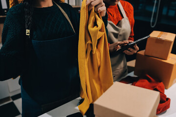 Portrait of Starting small businesses SME owners, two Asian woman check online orders Selling...