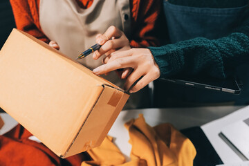 Portrait of Starting small businesses SME owners, two Asian woman check online orders Selling...