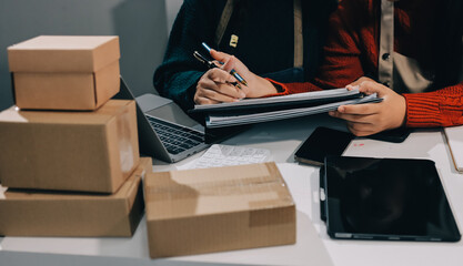 Portrait of Starting small businesses SME owners, two Asian woman check online orders Selling...