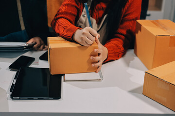 Portrait of Starting small businesses SME owners, two Asian woman check online orders Selling...