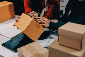 Portrait of Starting small businesses SME owners, two Asian woman check online orders Selling...