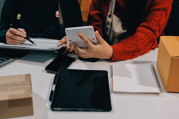 Portrait of Starting small businesses SME owners, two Asian woman check online orders Selling...