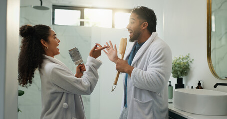 Fototapeta premium Couple, singing and morning routine in bathroom with love, energy and excited for dancing. Music, man and woman in home with brush for celebration, karaoke rhythm and bonding with funny partner