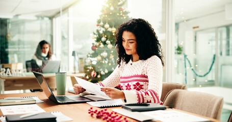 Woman, documents and review at Christmas in office with cold hands, winter and festive sweater at...