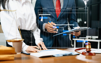 Business lawyers reviewing a contract and project timeline, blending law, justice, strategy, and...