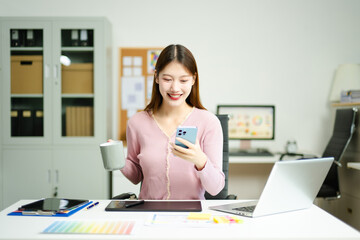 Happy creative designer works with coffee and laptop in modern office, showcasing productivity,...