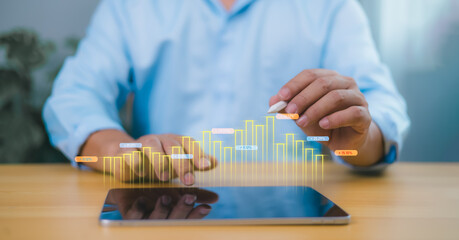 Growth in business performance visualized through a holographic bar graph from a tablet, showing a person analyzing digital data, symbolizing finance, innovation, and strategy.